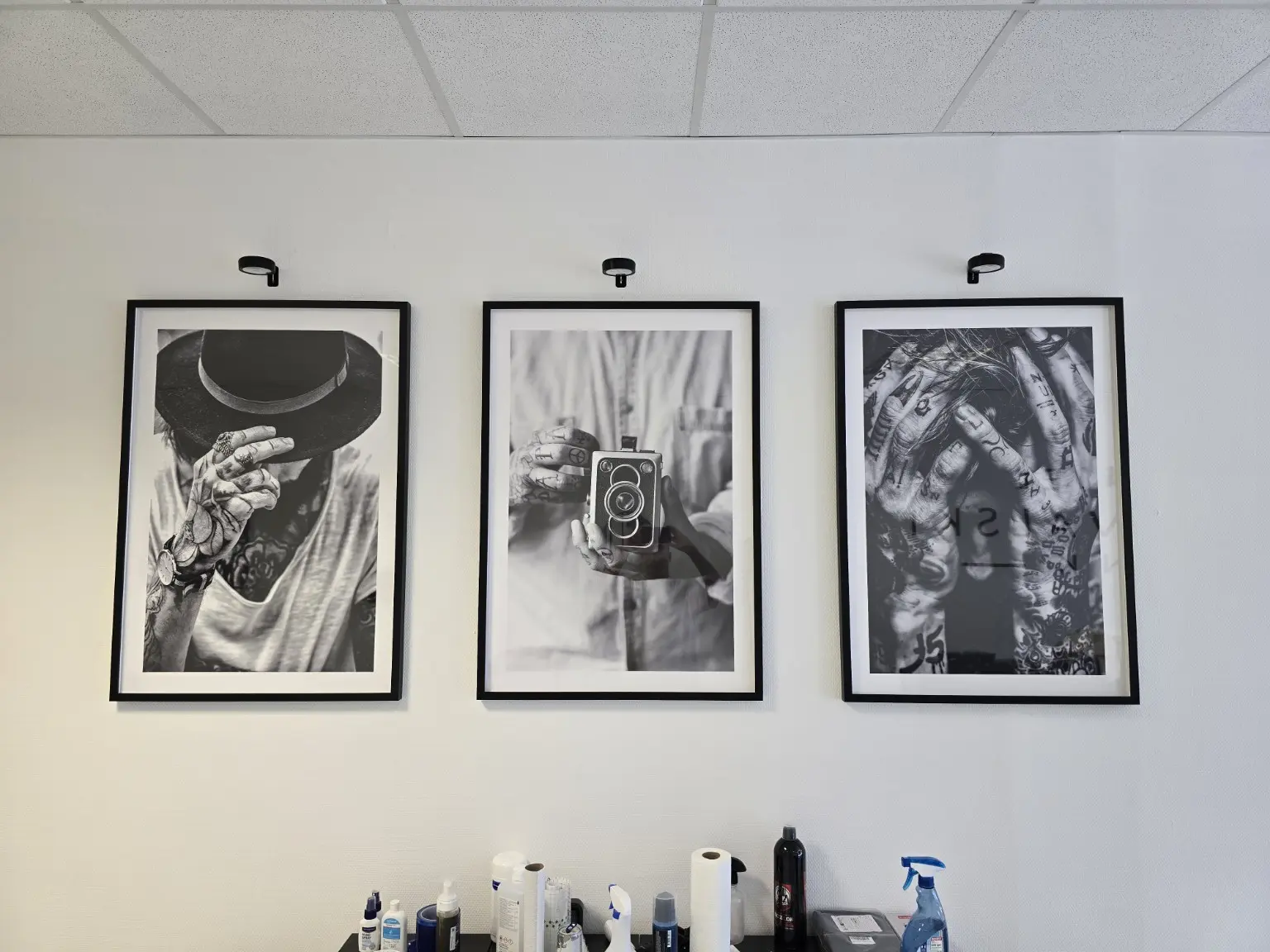 Drei gerahmte Schwarz-Weiß-Motive im Tattoo-Studio
